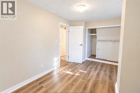 A room with a white door and a white cabinet.