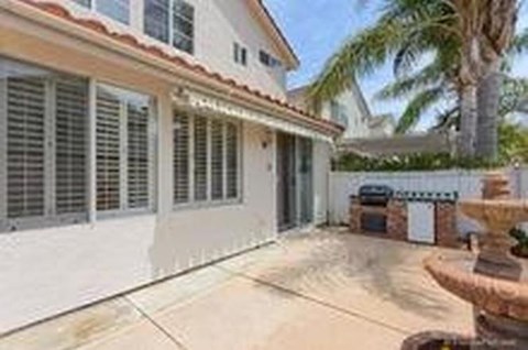 A house with a white exterior and a brown roof.