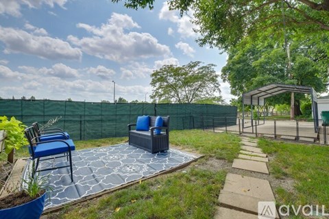A backyard with a patio, a hot tub, and a gazebo.