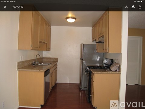 A kitchen with wooden cabinets and a granite countertop.