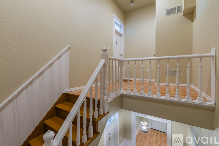A staircase with white railings and wooden steps.