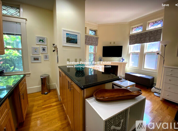 A kitchen with wooden cabinets and a black countertop.