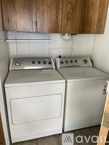 Two white ovens are in a kitchen.