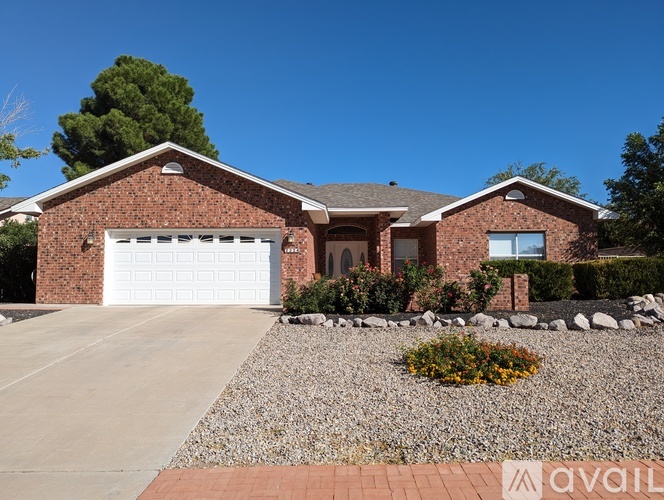 A house with a garage and a driveway in front.