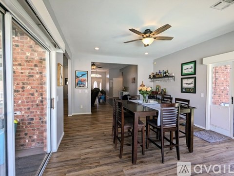 A dining room with a wooden table and chairs.