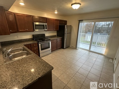 A kitchen with granite countertops and stainless steel appliances.