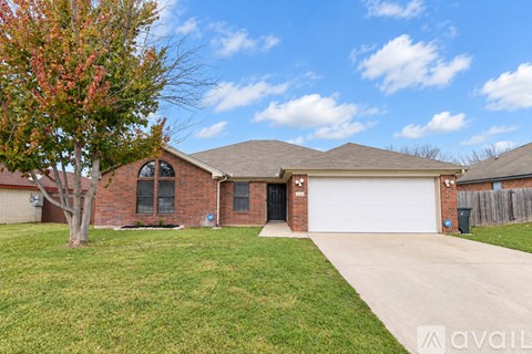 A house with a white garage door and a brick exterior.