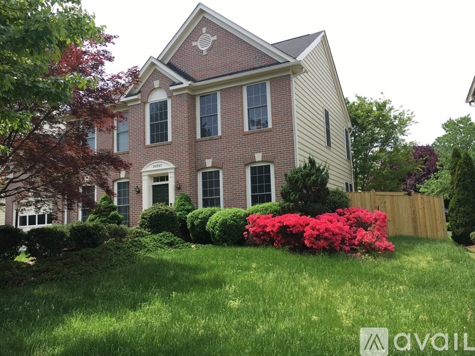 A house with a red brick facade and a white trim.