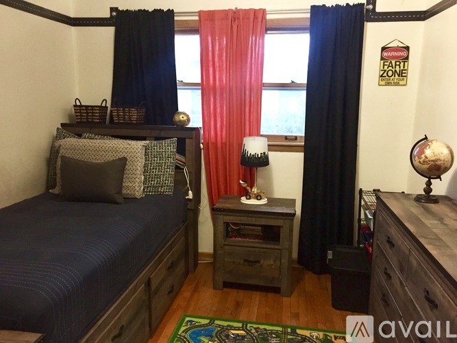 A bedroom with a bed, a nightstand, and a dresser.