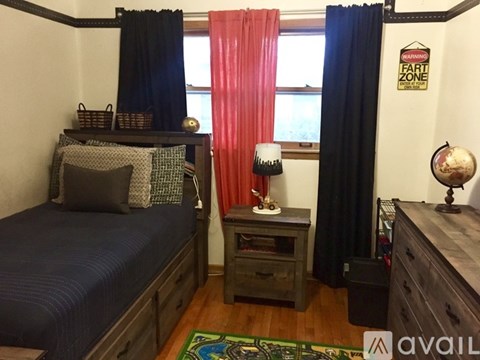 A bedroom with a bed, a nightstand, and a dresser.