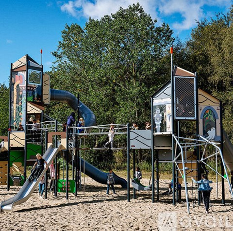 Kids playing on a playground slide.