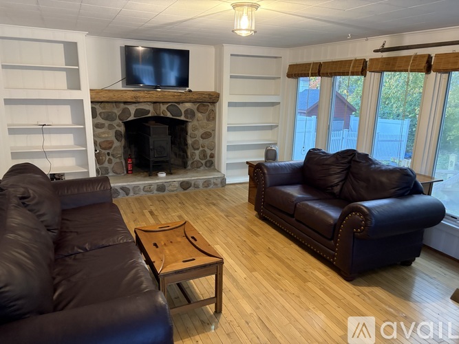 A living room with a fireplace and a television.