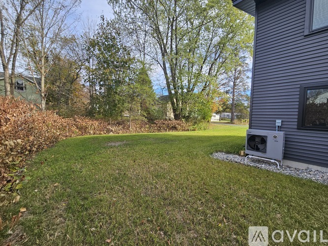 A backyard with a lawn and trees.