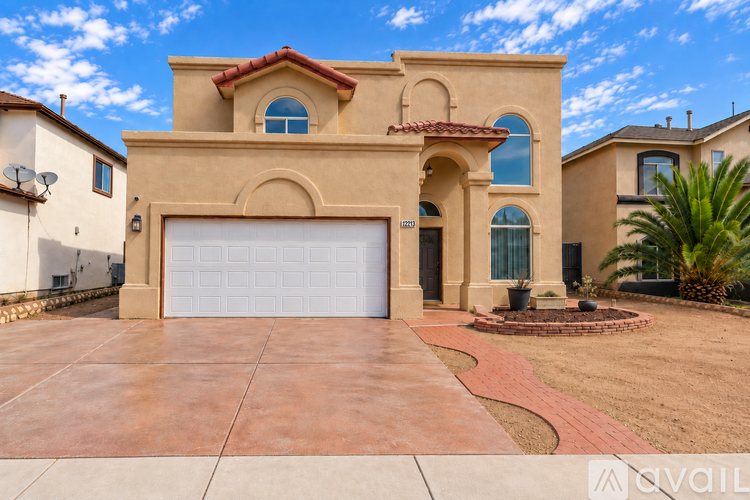 A house with a red tile roof and a white garage door.