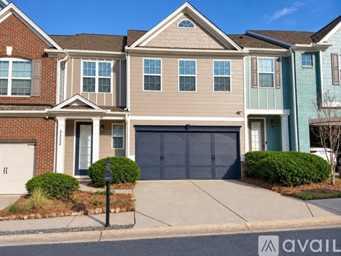 A row of houses with garages and driveways.