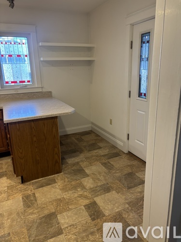 A kitchen with a counter and a door.