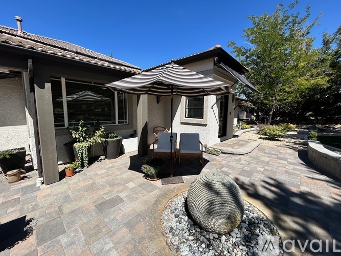 A patio area with a table and chairs is available for outdoor dining.