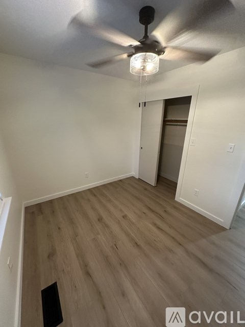A room with a ceiling fan and light fixture.