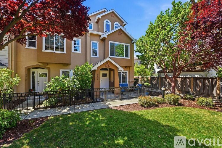 A house with a front yard and a fence.