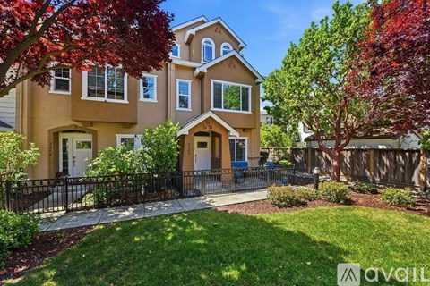 A house with a front yard and a fence.
