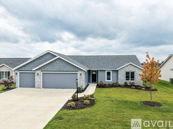 A house with a grey roof and a grey garage door is for sale.