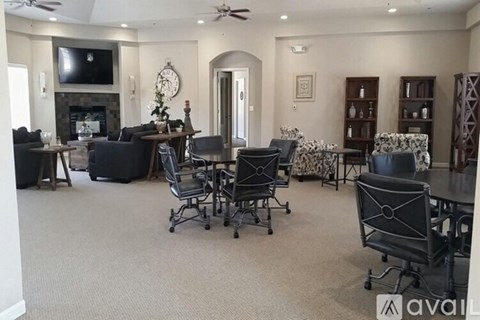 A living room with a fireplace and a television.