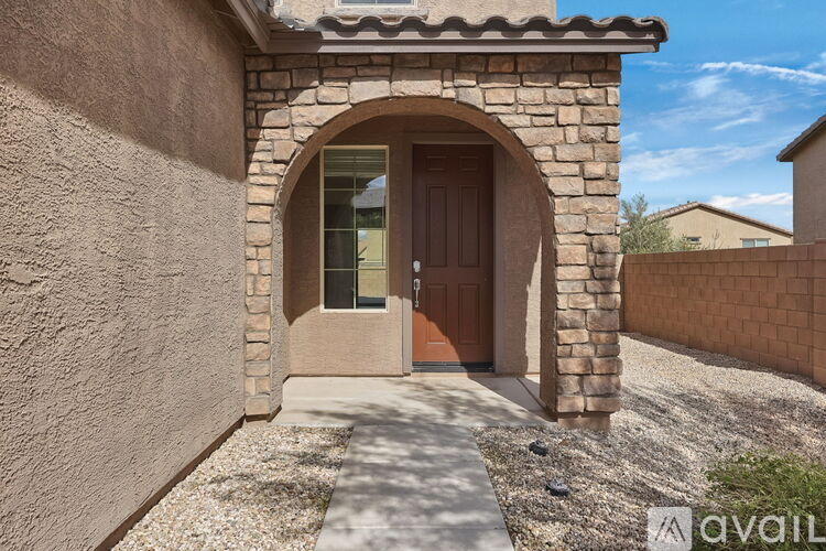 A house with a brown door and a stone archway entrance.
