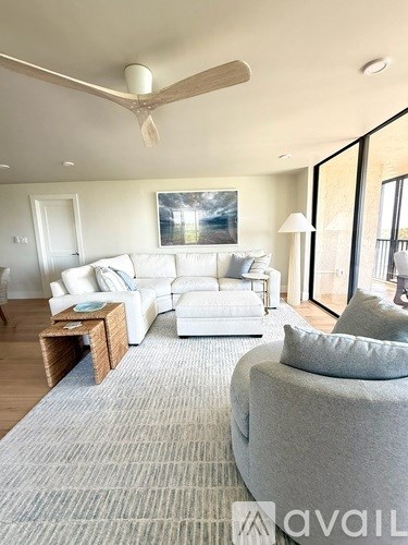 A living room with a grey sofa and a white couch.