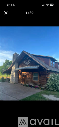 A wooden cabin with a porch and a chimney.