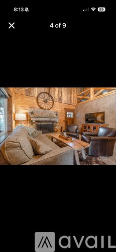 A cozy living room with a fireplace and a couch.