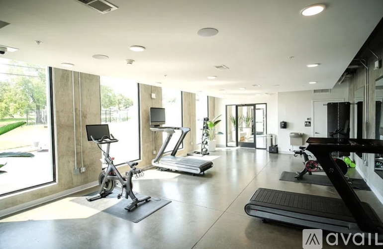 A gym with a treadmill, exercise bike, and other equipment.