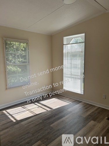 A sign in a room warning of scammers and stating that transactions should be done in person.