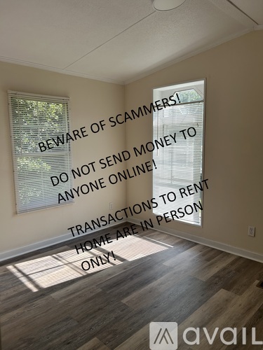 A room with a warning sign about scammers and instructions not to send money online.