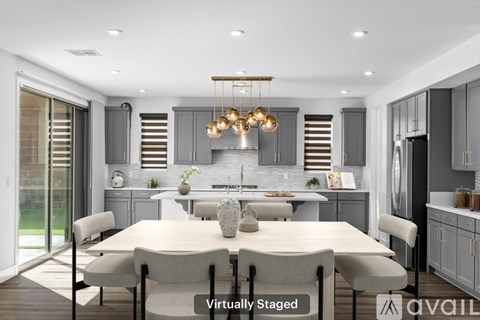 A modern kitchen with a dining table set for four.