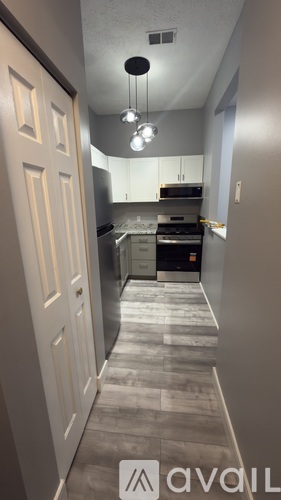A kitchen with a white door and a counter.
