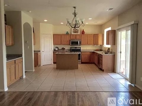 A kitchen with wooden cabinets and a central island.