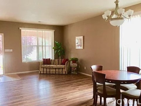 A dining room with a wooden table and chairs.