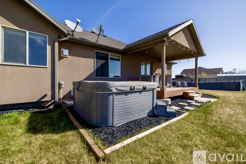 A house with a hot tub in the backyard.