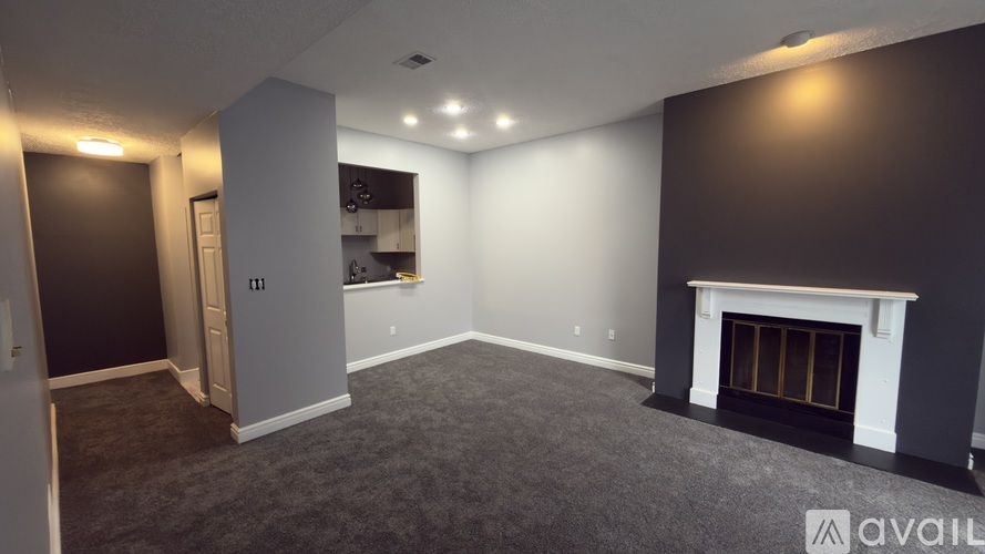 A room with a fireplace and a wall of cabinets.