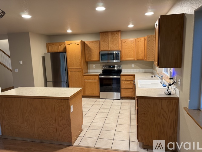 A kitchen with wooden cabinets and a white countertop.