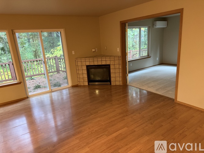 A living room with a television set and sliding glass doors.