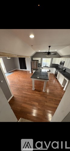 A kitchen with a table and chairs in the middle of the room.