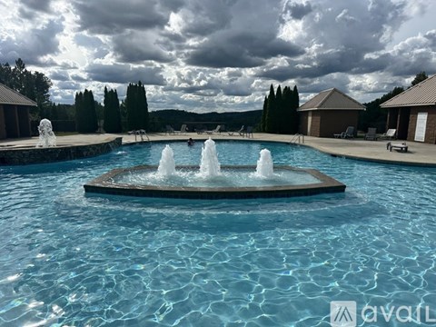 A large fountain in the middle of a swimming pool.