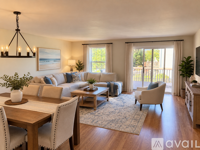 A living room with a wooden table and chairs, a couch, and a television.