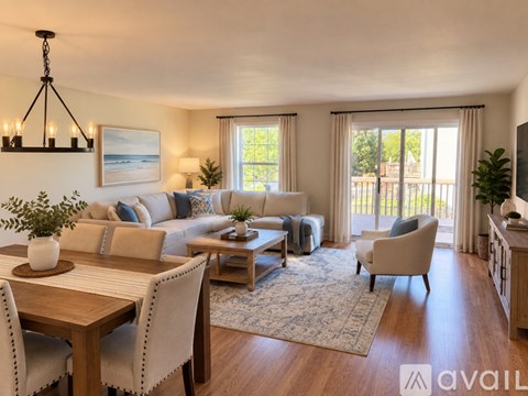 A living room with a wooden table and chairs, a couch, and a television.