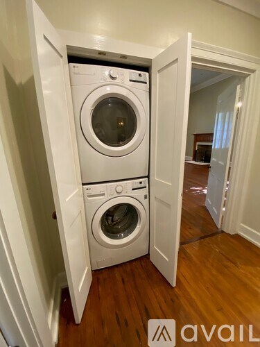 A white washing machine and dryer in a small laundry room.