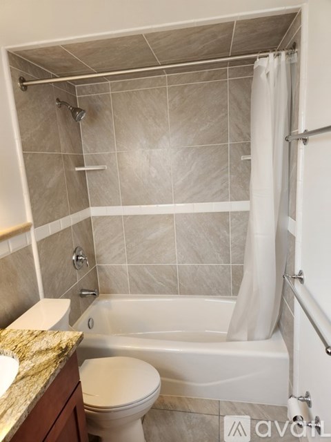 A bathroom with a toilet, sink, and bathtub.