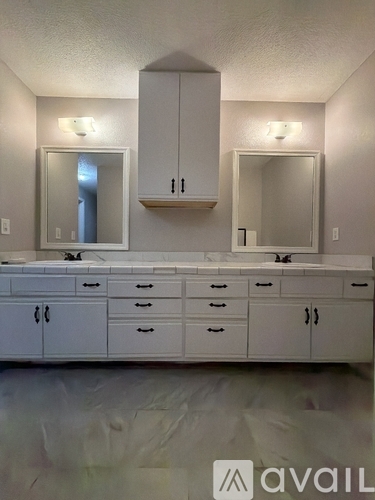 A bathroom vanity with a mirror above it.