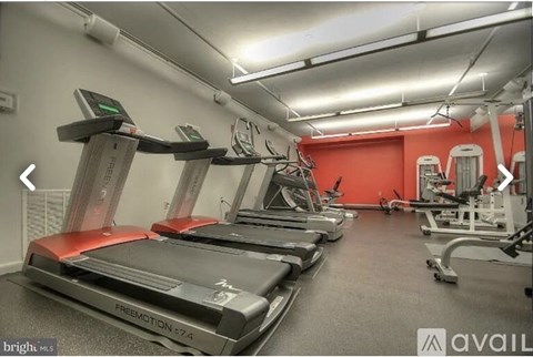 A gym with treadmills and elliptical machines.