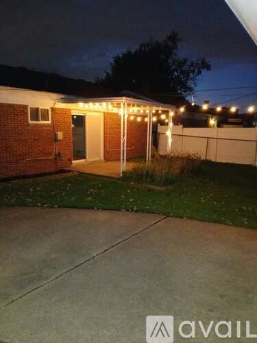 A house with a patio and lights on it.